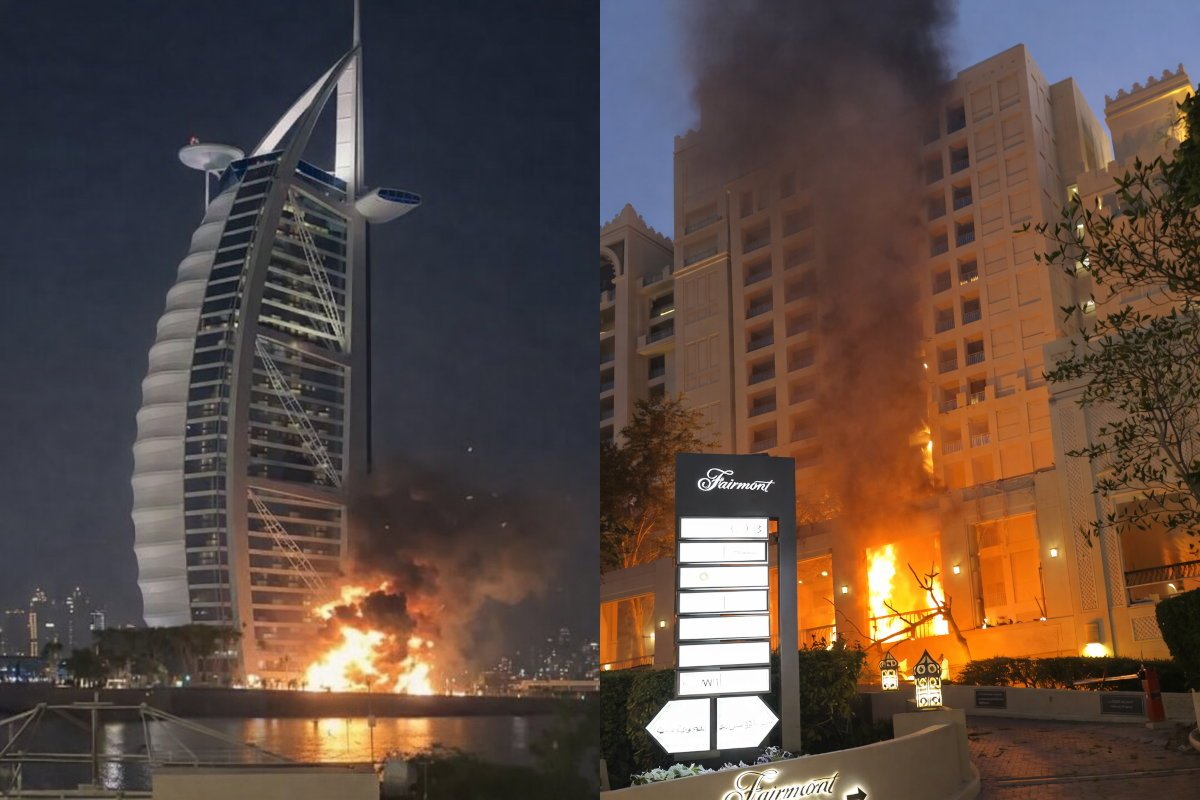Night-time image showing Fairmont The Palm at Palm Jumeirah and the Burj Al Arab with visible impact damage, smoke and small fires from missile/drone debris.