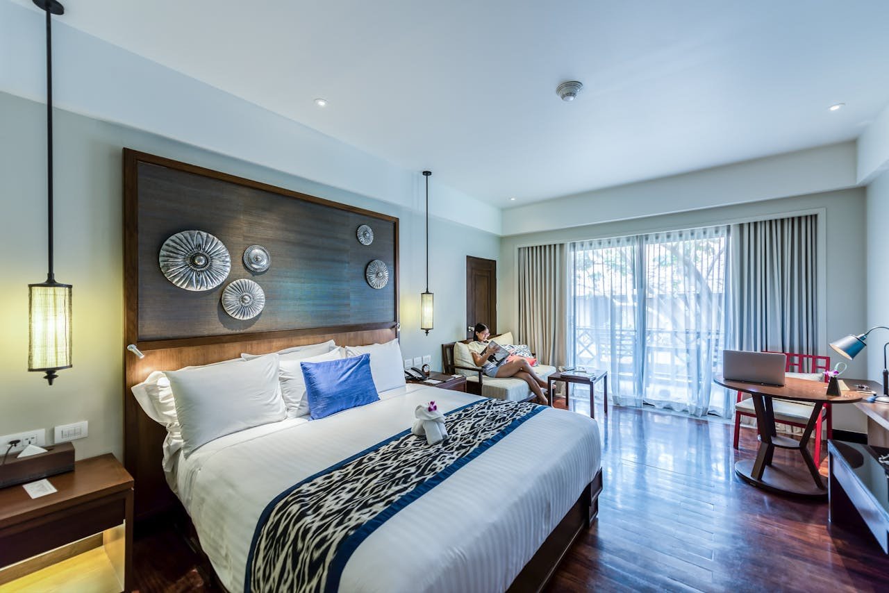 Original bedroom photograph with dark wood furniture and blue accents